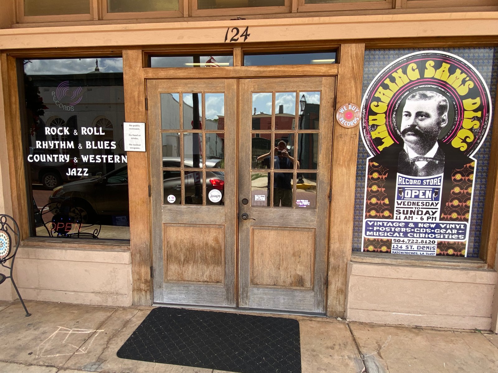 Inside Laughing Sam's Discs — walls packed with album art, record bins, and vintage memorabilia
